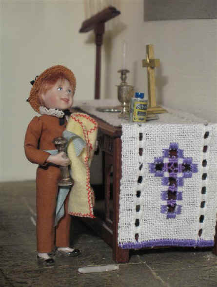 Ben is in the sanctuary cleaning the silver candlesticks on the altar.