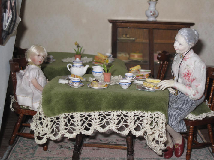 Alice serves Miss Enid and Alice and they are now enjoying some sandwiches and cakes and, of course, a nice cup of tea!