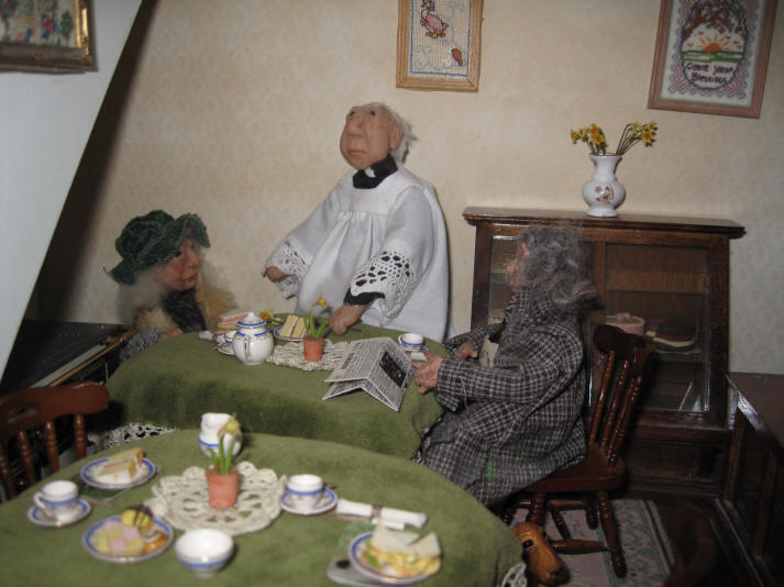 Homer and Rita enjoy a spot of warmth in Aunt Sal's Tearooms whilst having a spot of lunch courtesy of kind Archie who owns the tearooms.  The vicar has come in for a chat!