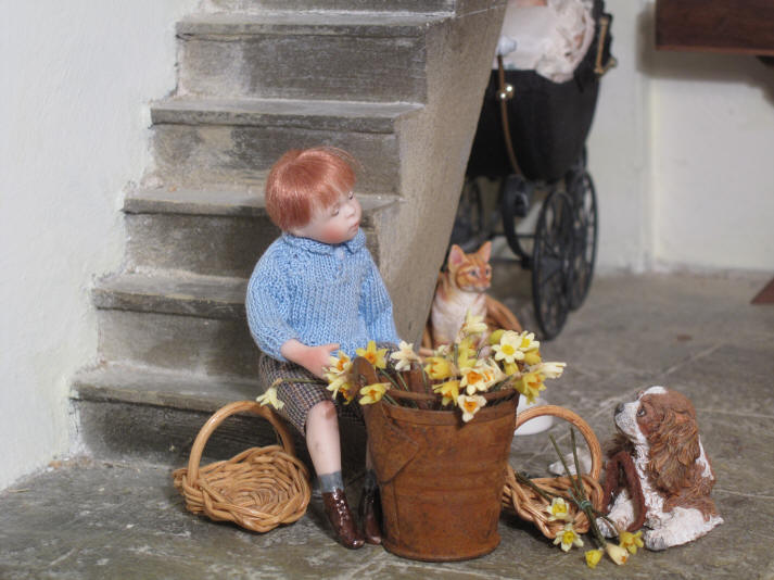 Robert Alexander is "helping" the vicar by putting the daffodils into the two basket in readiness for today's procession.