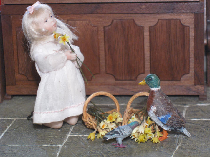 Priscilla Jane admires the daffodils alongside Eric and Syd!