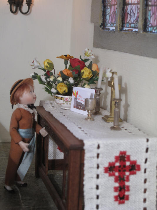 Ben places his card on the altar.  As you can see he has created a picture with his verison of St. Hilary's on it and has put some flames coming out of the tower to represent the Holy Spirit as a fire.