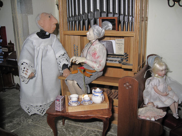 Miss Enid is telling the vicar that she has made him a lovely cup of tea in her very own bone china teapot!